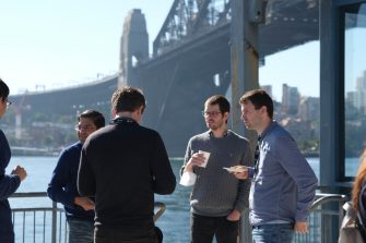 Group chatting beside Sydney Harbour Bridge