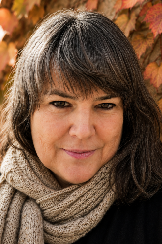 A photo of Melody Ellis, a middle-aged white woman with shoulder-length brown hair.