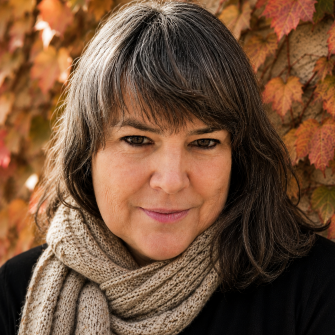 A photo of Melody Ellis, a middle-aged white woman with shoulder-length brown hair.