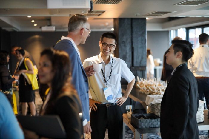 People networking at the symposium