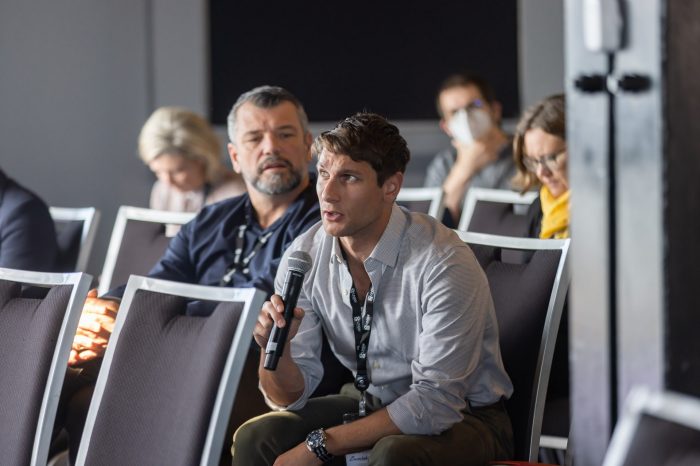 Man from audience asking speaker a question