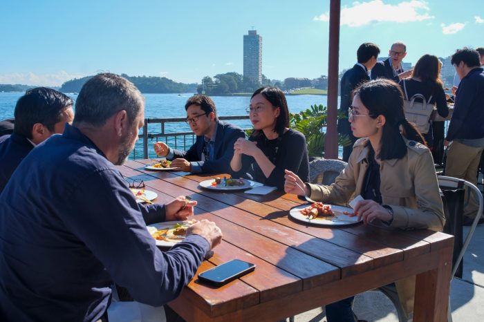 Group eating lunch by the harbour