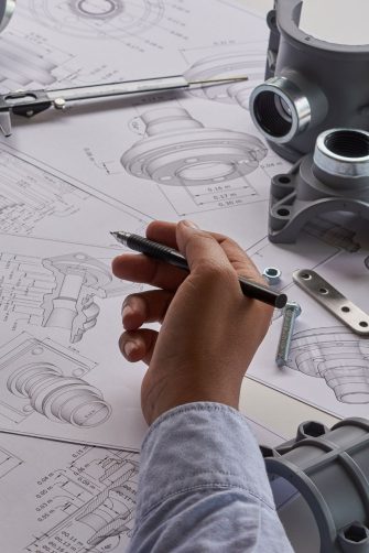 Photo of engineer technician drawing mechanical parts