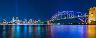 Photo of Sydney city lights, Opera House, and Harbour Bridge at night during Vivid festival