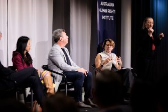 a panel discussion with a banner of Australian Human Rights Institute