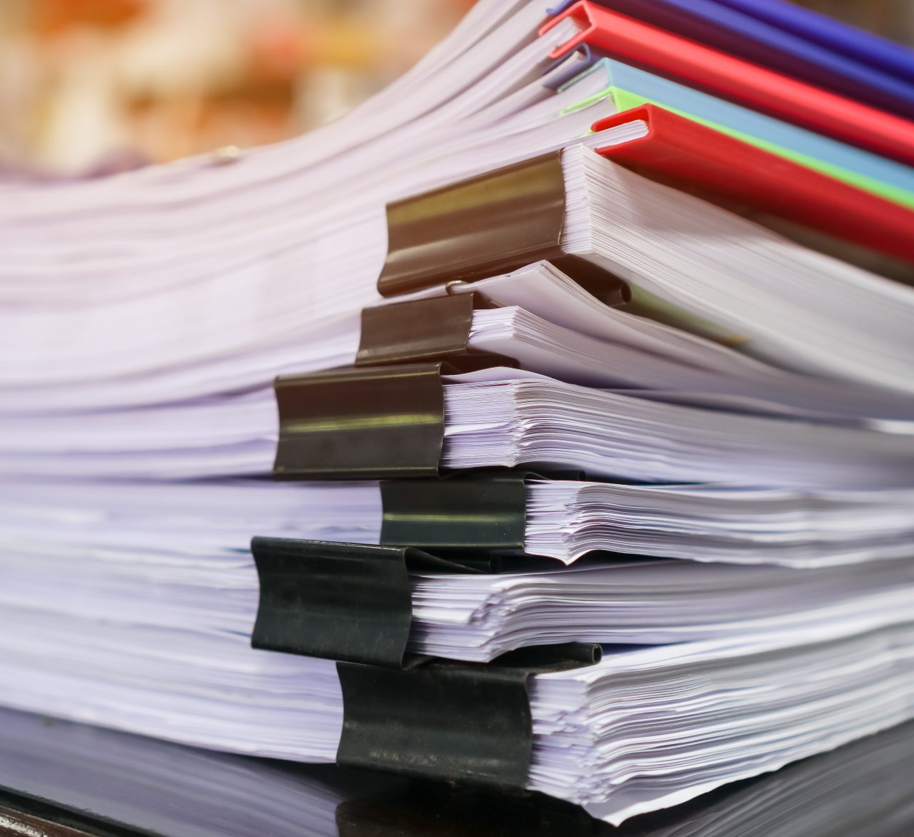 Stacks of papers documents files information business report papers with color clips paper, piles of unfinished achieves with laptop computer desk in modern office, Accounting planning budget concept