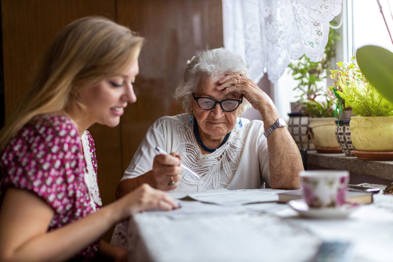 Young woman helping elderly person