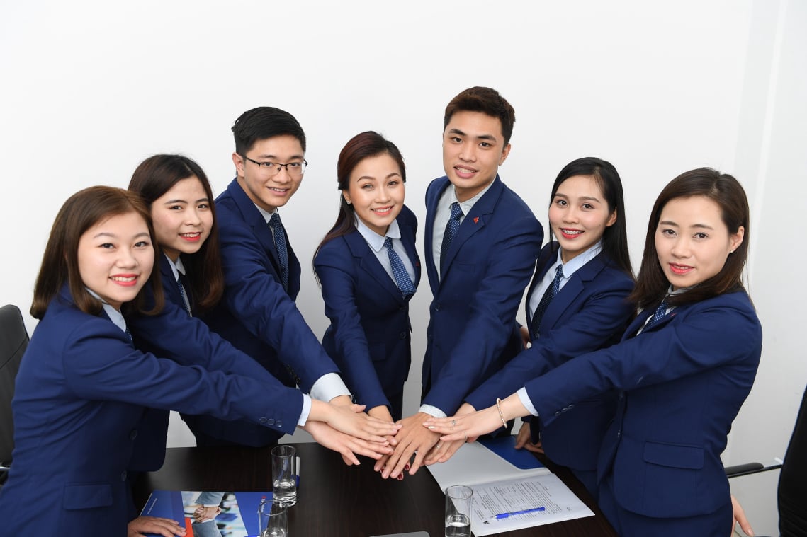 group putting hands together in centre
